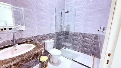 a bathroom with a toilet and a sink at Panorama Hotel in Luxor