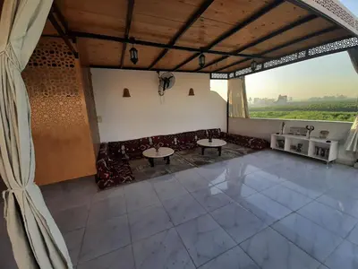 a room with a couch and tables and a window at Panorama Hotel in Luxor