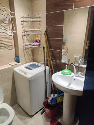 a bathroom with a sink and a toilet and a sink at Florenza khamsin compound unit g4 in Hurghada