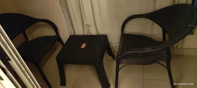 two black chairs and a table in a room at Florenza khamsin compound unit g4 in Hurghada