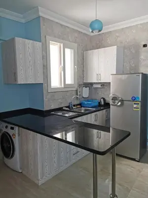 a kitchen with a counter top and a refrigerator at Schöne Europäische 3 Zimmer Wohnung in Al Dahar in Hurghada