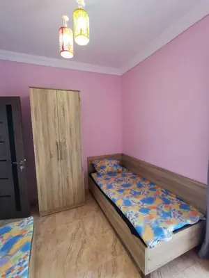 a bedroom with a bed and a wooden cabinet at Schöne Europäische 3 Zimmer Wohnung in Al Dahar in Hurghada