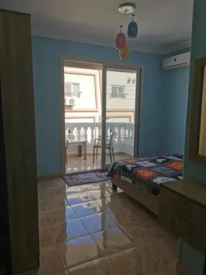 a bedroom with a bed and a dining room with a table at Schöne Europäische 3 Zimmer Wohnung in Al Dahar in Hurghada