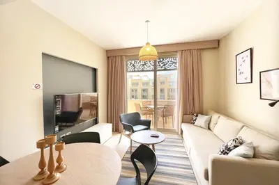 a living room with a couch and a table at Smooth & Snug 1 BDR Mangroovy Free Beach & Pool Access in Hurghada