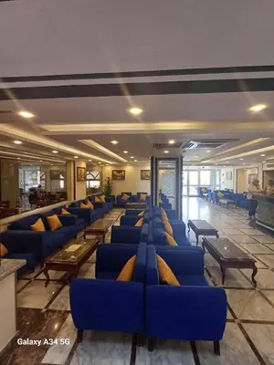 a row of blue chairs in a waiting room at Palm Inn Hotel Hurghada in Hurghada