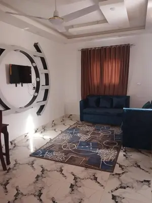 a living room with a blue couch and a mirror at Sky Guest House in Luxor