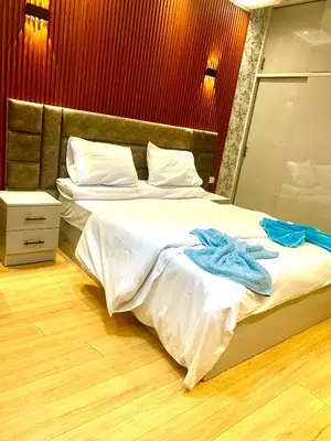 a bedroom with a large bed with towels on it at Sunny studio with 3 swimming pools Florenza Hurghada in Hurghada