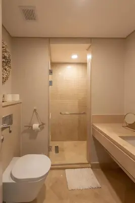 a bathroom with a shower with a toilet and a sink at Mangroovy - Spacious Boho 2 BR Pool view in Hurghada