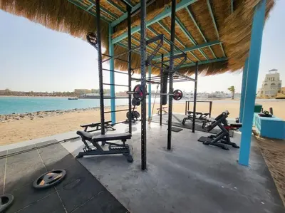 a gym with several treadmills and machines on the beach at Mangroovy - Spacious Boho 2 BR Pool view in Hurghada