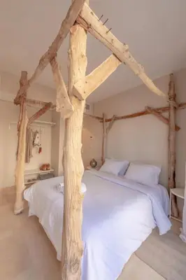 a bedroom with two beds with wooden beams at Mangroovy - Spacious Boho 2 BR Pool view in Hurghada
