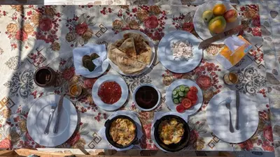 a table with plates of food on a table at Karima House in Luxor