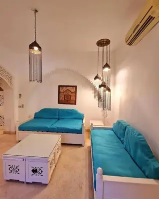 a living room with two beds and a couch at Cozy apartment in Downtown Gouna in Hurghada