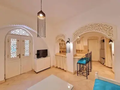 a large kitchen with a table and chairs in a room at Cozy apartment in Downtown Gouna in Hurghada