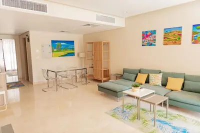 a living room with a couch and a table at Cozy 1 Bedroom Ground Floor Apartment with Pool in Hurghada