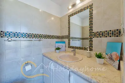 a bathroom with a sink and a mirror at 2-BR Penthouse with roof terrace in Abu Tig Marina in Hurghada