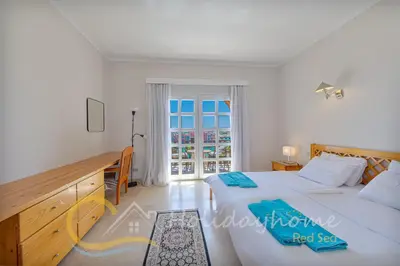 a bedroom with a large bed and a window at 2-BR Penthouse with roof terrace in Abu Tig Marina in Hurghada