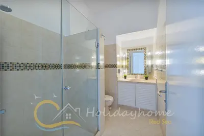 a bathroom with a shower and a toilet and a sink at 2-BR Penthouse with roof terrace in Abu Tig Marina in Hurghada