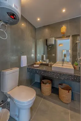 a bathroom with a toilet and a sink at Tropical 2BR Paradise in Bali, El Gouna. Pool, Patio & BBQ in Hurghada