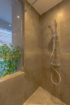 a shower with a shower head in a bathroom at Tropical 2BR Paradise in Bali, El Gouna. Pool, Patio & BBQ in Hurghada
