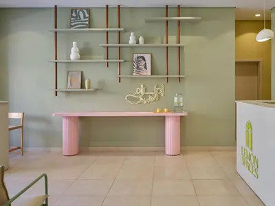 a pink table in a room with shelves at Boutique Residence Mangroovy-Lemon Spaces Gouna in Hurghada
