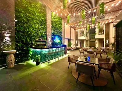 a restaurant with tables and chairs and a green wall at Imperial Resort Hurghada-The Hurghada Hideaway in Hurghada