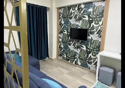 a living room with a tv and a couch at Princess resort in Hurghada