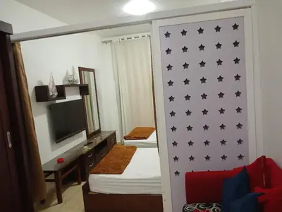 a bedroom with a wall with black stars on it at Turtle beach apartment in Hurghada