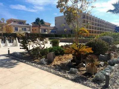 a garden with trees and plants in front of a building at Selena bay in Hurghada