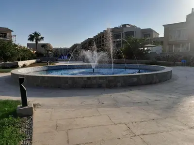 a fountain with two fountains in a park at Selena bay in Hurghada