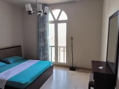 a bedroom with a bed and a large window at Roof top apartment with panorama view in Hurghada