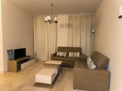 a living room with a couch and a tv at Roof top apartment with panorama view in Hurghada