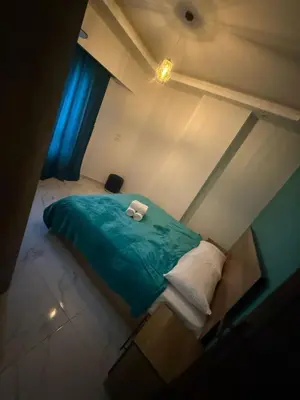 a bedroom with a green bed with two towels on it at Juliana resort beach - Julia apartment in Hurghada