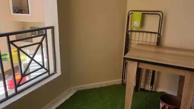 a room with a table and a window and green carpet at Juliana resort beach - Julia apartment in Hurghada