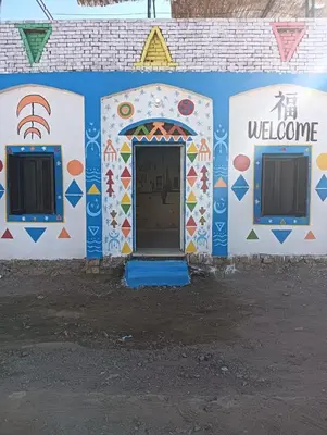 a building with a door with a welcome sign on it at king kassem nubian guest house in Aswan