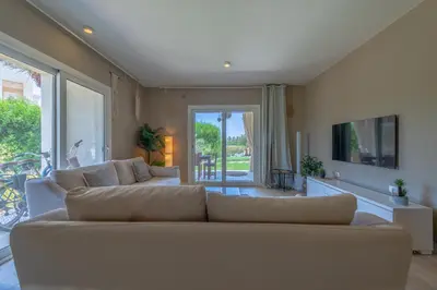 a living room with a couch and a tv at 1-Bedroom Apartment in Joubal with nice Pool in Hurghada