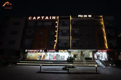 a building with neon signs on it at night at FOX SAHEL AQUA RESORT ELGOUNa& Kite in Hurghada