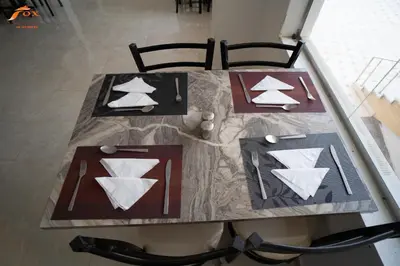 a table with two chairs and a table with two paper planes at FOX SAHEL AQUA RESORT ELGOUNa& Kite in Hurghada