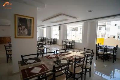 a dining room with a table and chairs at FOX SAHEL AQUA RESORT ELGOUNa& Kite in Hurghada
