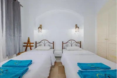 two beds in a room with blue towels on them at 3-Bedroom Apartment - Great location- Upper Nubia in Hurghada