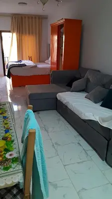 a living room with two beds and a couch at Turtles beach resort hourghada studio view sea view pool private beach jacuzzi security air-conditioned Cafe restaurant on the beach and a large sunny balcony in Hurghada