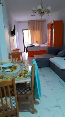 a living room with a table and a couch at Turtles beach resort hourghada studio view sea view pool private beach jacuzzi security air-conditioned Cafe restaurant on the beach and a large sunny balcony in Hurghada