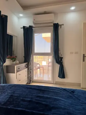 a bedroom with a bed and a window at Inter Prime apartment 3 in Hurghada