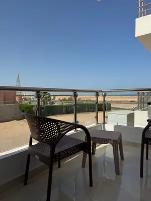 a balcony with chairs and a view of the beach at Inter Prime apartment 3 in Hurghada