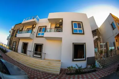 a large white building with stairs in front of it at Inter Prime apartment 3 in Hurghada