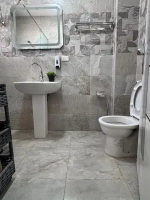 a bathroom with a sink and a toilet and a mirror at Inter Prime apartment 3 in Hurghada