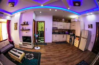 a living room with purple lights on the ceiling at Inter Prime apartment 2 in Hurghada
