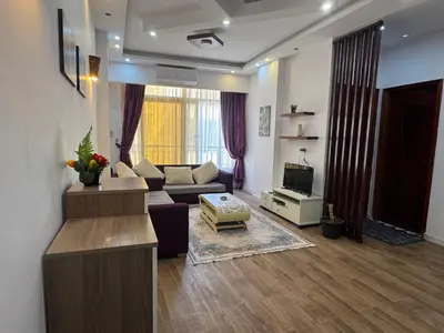a living room with a couch and a tv at Inter Prime apartment 2 in Hurghada