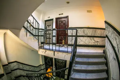 a person sitting on a staircase in a building at Inter Prime apartment 2 in Hurghada