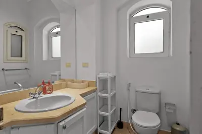 a bathroom with a sink and a toilet and a mirror at The Seafront Magical Loft! in Hurghada
