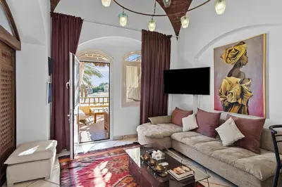 a living room with a couch and a table at The Seafront Magical Loft! in Hurghada